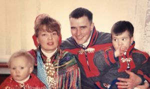 A family of four pose for a picture dressed in traditional clothing from the Sami people of northern Scandinavia